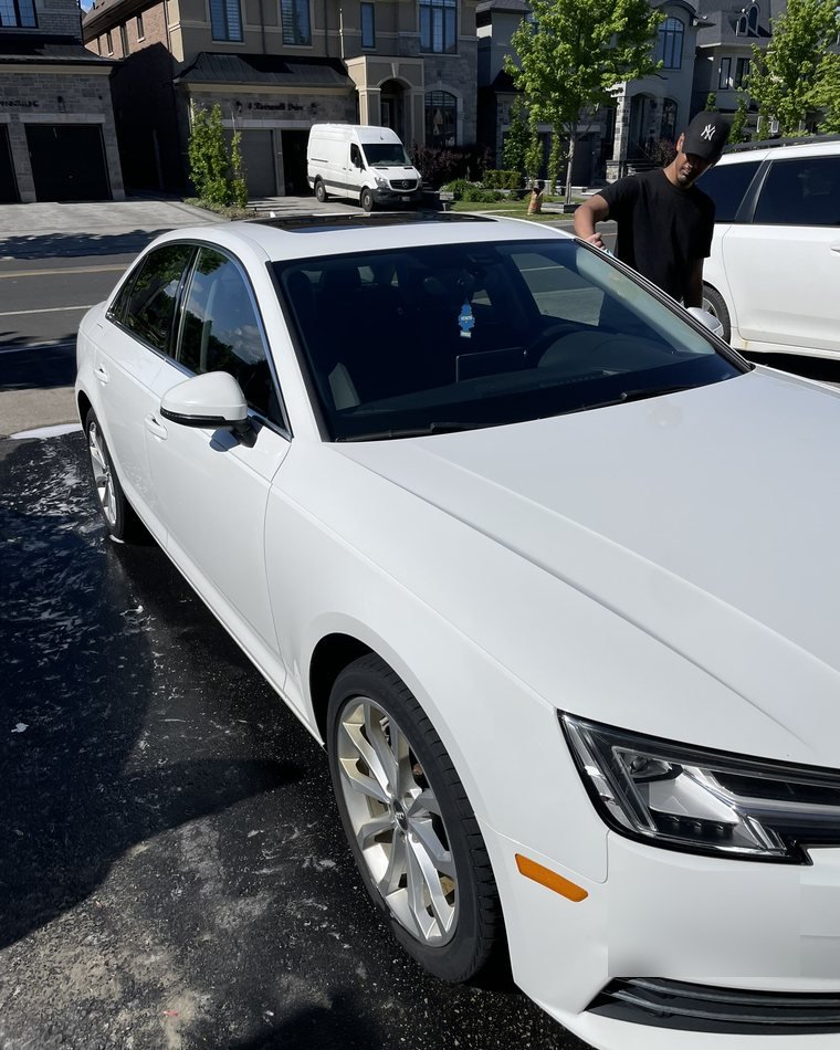 Prime Auto Care detailing a white Audi in a residential driveway